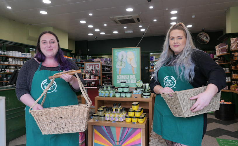 Body Shop staff standing next to products at Bristol store
